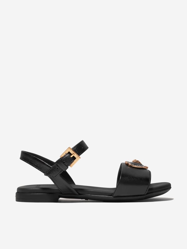 Introducing the Versace Girls Leather Heart Logo Sandals in Black, an opulent blend of Italian craftmanship and fashionable utility, perfect for holiday ensembles. Key highlights include: Italian-made: Born from the masterful techniques of Italian artisanship, rendering it durable and timelessly elegant. Heart Logo Accent: Elevate your child's style quotient with the iconic Versace heart logo, making these sandals a true statement piece. Supreme Comfort: Fabricated from premium leather ensuring comfort and ease, accompanying your child's every step.Transform the Holiday wardrobe! With these Versace Girls Leather Heart Logo Sandals in Black. Shop now for a taste of luxury for your little fashionista!