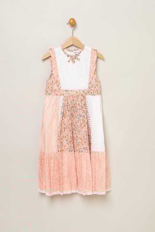 Let your little one blossom in this Miss floral patchwork dress! Designed with a keyhole tie neck and cute frill sleeves, it's a delightful addition to her wardrobe. Each patch tells a floral story, adding charm to every wear. Perfect for your stylish sweetheart to shine in any setting.