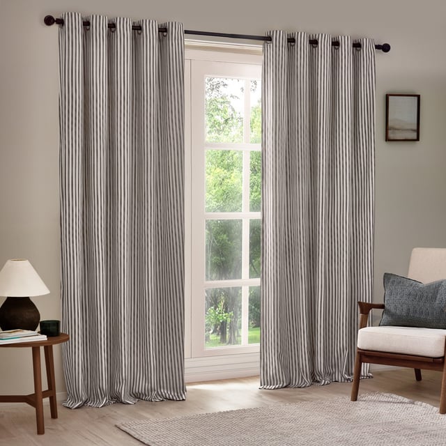 Transform your living space with Hebden Striped Eyelet Curtains. Crafted from 100% cotton, these woven striped curtains offer a super soft yet durable finish, ensuring long-lasting beauty and ease. Perfectly balancing style and substance, the versatile design exudes a classic minimalist charm, while the room-darkening lining adds practicality. Whether you're seeking serenity or a restful night’s sleep, these curtains deliver quality, making them an essential addition for those who cherish natural materials and refined aesthetics.