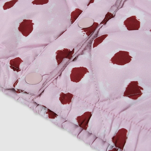 Lightweight cotton mix quilted jacket with our bespoke painted dot print in pale pink with burgundy dots. Inside lining and ribbed collar in matching burgandy jersey to the burgundy dots to give our little ones extra warmth and comfort. Features press stud front opening for ease of dressing.