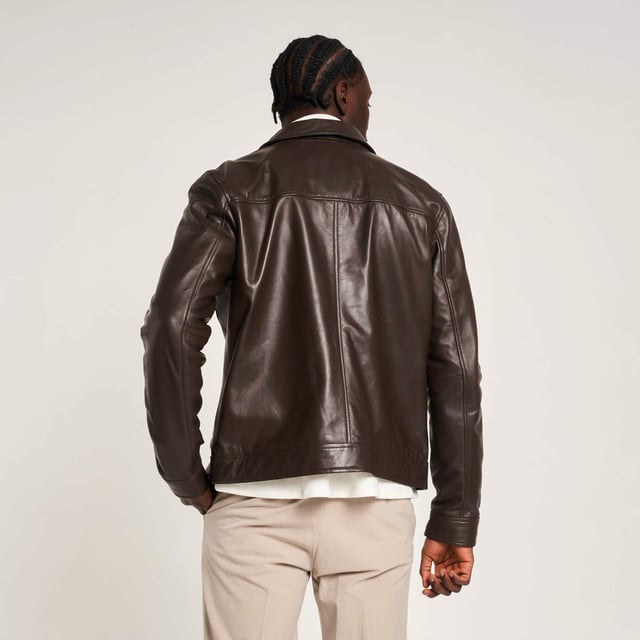 Introducing the Barneys Originals Brown Leather Harrington jacket - a timeless piece crafted for the modern adventurer. With its rich brown hue and classic Harrington silhouette, this jacket exudes rugged sophistication. Perfect for any occasion, whether you're exploring the city streets or unwinding in the countryside, it's the epitome of versatile style and enduring quality.