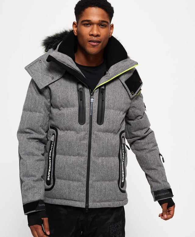 Superdry men’s Deluxe Nordic snow puffer jacket. This padded weather tolerant jacket with an inner ribbed collar, detachable hood with a removable faux fur trim and a taped seam zip fastening is perfect for hitting the slopes in. The Deluxe Nordic snow puffer jacket features five outer pockets – one with a detachable goggle cloth, hook and loop fastened cuffs with thumbholes and zip fastened armpit ventilation. Inside, the jacket has a removable snow skirt and a single internal pocket with earphone routing. The jacket is finished with Superdry branding on the zips, placket, shoulder and arms. Water resistance  10,000mm 
Breathability  10,000g
Snow seals and coated zipsModel wears: Medium Model height: 6’ 1” (185cm) Model chest size: 38" (96cm)
