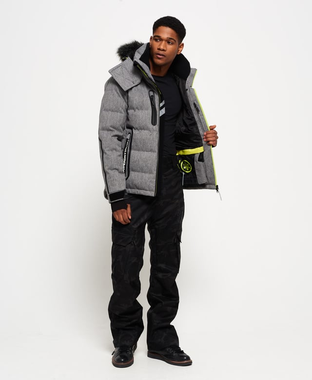 Superdry men’s Deluxe Nordic snow puffer jacket. This padded weather tolerant jacket with an inner ribbed collar, detachable hood with a removable faux fur trim and a taped seam zip fastening is perfect for hitting the slopes in. The Deluxe Nordic snow puffer jacket features five outer pockets – one with a detachable goggle cloth, hook and loop fastened cuffs with thumbholes and zip fastened armpit ventilation. Inside, the jacket has a removable snow skirt and a single internal pocket with earphone routing. The jacket is finished with Superdry branding on the zips, placket, shoulder and arms. Water resistance  10,000mm 
Breathability  10,000g
Snow seals and coated zipsModel wears: Medium Model height: 6’ 1” (185cm) Model chest size: 38" (96cm)
