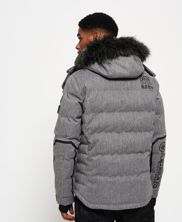 Superdry men’s Deluxe Nordic snow puffer jacket. This padded weather tolerant jacket with an inner ribbed collar, detachable hood with a removable faux fur trim and a taped seam zip fastening is perfect for hitting the slopes in. The Deluxe Nordic snow puffer jacket features five outer pockets – one with a detachable goggle cloth, hook and loop fastened cuffs with thumbholes and zip fastened armpit ventilation. Inside, the jacket has a removable snow skirt and a single internal pocket with earphone routing. The jacket is finished with Superdry branding on the zips, placket, shoulder and arms. Water resistance  10,000mm 
Breathability  10,000g
Snow seals and coated zipsModel wears: Medium Model height: 6’ 1” (185cm) Model chest size: 38" (96cm)
