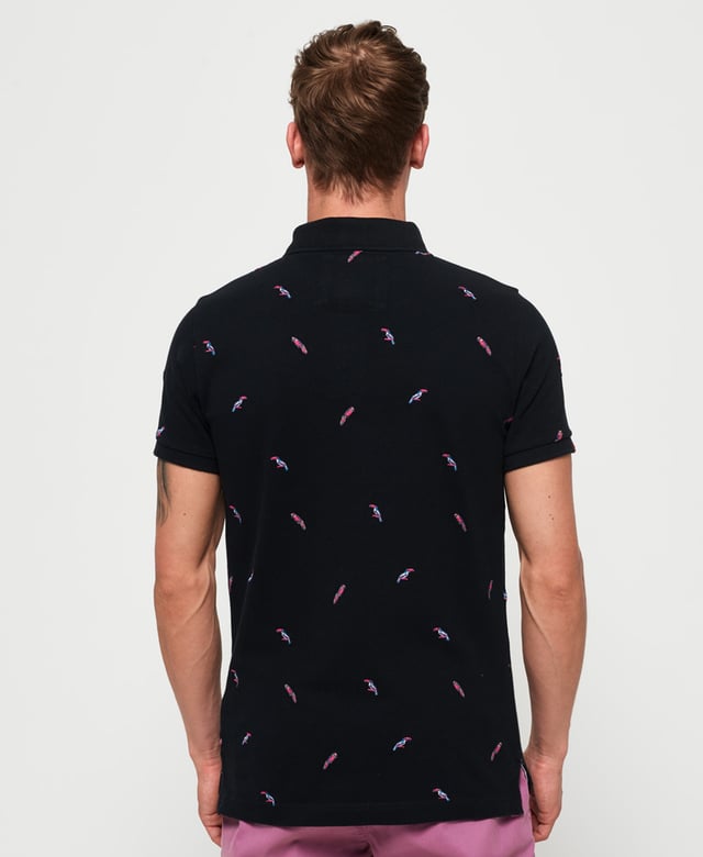 Superdry men's Bermuda polo shirt. This classic style polo shirt features short sleeves, two button fastening and an all over embroidered pattern. Finished with a Superdry logo tab on the hem and on one sleeve. Will look great with a pair of jeans or shorts and trainers this season.