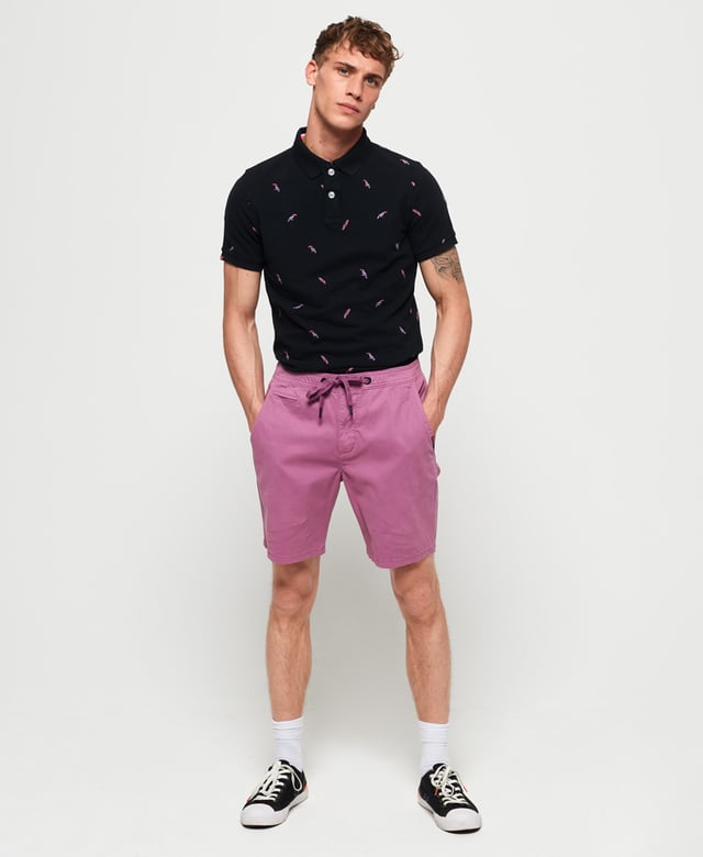 Superdry men's Bermuda polo shirt. This classic style polo shirt features short sleeves, two button fastening and an all over embroidered pattern. Finished with a Superdry logo tab on the hem and on one sleeve. Will look great with a pair of jeans or shorts and trainers this season.