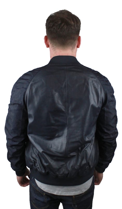 Emporio Armani W1B54P W1P58 0011 Leather Jacket. Black Leather Jacket. Two Way Central Zip Closure. Elasicated Waist and Sleeve Endings. Polyester Arms With Camo Print. Branded Badge on Left Shoulder