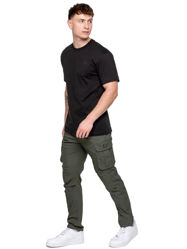 Upgrade your everyday style with the Enzo Men's Cargo Pants. Crafted from premium stretch fabric, these lightweight trousers offer a tapered leg fit for a sleek, modern look. Featuring an elasticated waistband with an adjustable toggle, they provide a customizable fit, while the adjustable toggle ankles let you tailor the look and feel. With two side slash pockets, two cargo pockets with secure Velcro fastening, and a single back welt pocket, you’ll have ample storage for essentials. Finished with an Enzo print on the cargo pocket. (649)