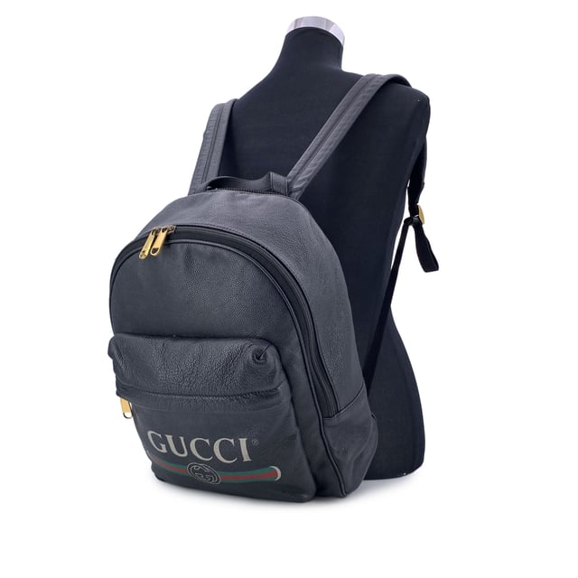 VINTAGE, RRP AS NEW
This beautiful Bag will come with a Certificate of ity provided by Entrupy. The certificate will be provided at no further cost  Elevate your daily style with this functional yet luxurious Gucci backpack. Crafted from rich black leather, this versatile piece is the perfect combination of sleek design and practicality. The front pocket, subtly accented with a vintage Gucci logo, adds a touch of heritage to the modern silhouette, making it an iconic statement for those who appreciate refined craftsmanship.  The zipper closure opens to reveal a spacious interior lined in beige fabric, offering plenty of room for your essentials-whether you're heading to work, running errands, or embarking on travel adventures. For added organization, the interior also features a side zip closure pocket, perfect for keeping smaller items secure. The adjustable shoulder straps ensure a customizable fit for ultimate comfort, making it the ideal companion for your daily commutes or getaway escapes. With its timeless appeal and effortless elegance, this Gucci backpack brings a touch of luxury to every journey. 'Gucci - Made in Italy' tag inside (with serial number on its reverse).    Condition Rating: B - VERY GOOD CONDITIONCondition Details: Gently used. Some stains on the internal lining. Some wear of use on bottom corners. Please check the photos carefully and ask if you need to know more details or if you have any doubts.Measurements (cm):Depth: 17.8Height: 38.1Length: 34.3Other Details: Dustbag? NoKeys? NoBox? No Measurments:  width: 178 mm length: 343 mm height: 381 mm
