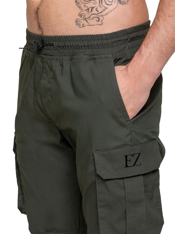 Upgrade your everyday style with the Enzo Men's Cargo Pants. Crafted from premium stretch fabric, these lightweight trousers offer a tapered leg fit for a sleek, modern look. Featuring an elasticated waistband with an adjustable toggle, they provide a customizable fit, while the adjustable toggle ankles let you tailor the look and feel. With two side slash pockets, two cargo pockets with secure Velcro fastening, and a single back welt pocket, you’ll have ample storage for essentials. Finished with an Enzo print on the cargo pocket. (649)