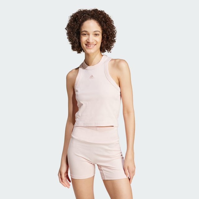 Whether you're spending the day at home or meeting friends for brunch, this adidas tank top lets you move comfortably. Made from stretchy cotton blend fabric, it hugs your shape while side slits provide a gentle fit at the waist. Subtle embroidery adds a stylish touch to this otherwise minimal look.By choosing recycled, adidas are able to reuse materials that have already been created, which helps to reduce waste. Renewable materials choices will help us to remove our reliance on finite resources. Our products made with a blend of recycled and renewable materials feature at least 70% total of these materials.  - This model is 176 cm and wears a size S. Their chest measures 83 cm and the waist 61 cm. - Tight fit - Crewneck - 45% cotton, 45% viscose, 10% elastane - Stretchy bodyhugging fabric - Side slits - Embroidered details - Contains a minimum of 70% recycled and renewable content  Shipped by adidas