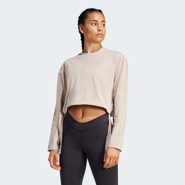Take your yoga flow from studio to city in this yoga cover-up. Made for comfort inside and out, this soft French terry top keeps you cosy before, during and after your practice. adidas AEROREADY keeps you dry when the heat is on. Slightly cropped and with hem ties, this cover-up layers perfectly over your favourite yoga bra.By choosing recycled, adidas are able to reuse materials that have already been created, which helps to reduce waste. Renewable materials choices will help us to remove our reliance on finite resources. Our products made with a blend of recycled and renewable materials feature at least 70% total of these materials.  -