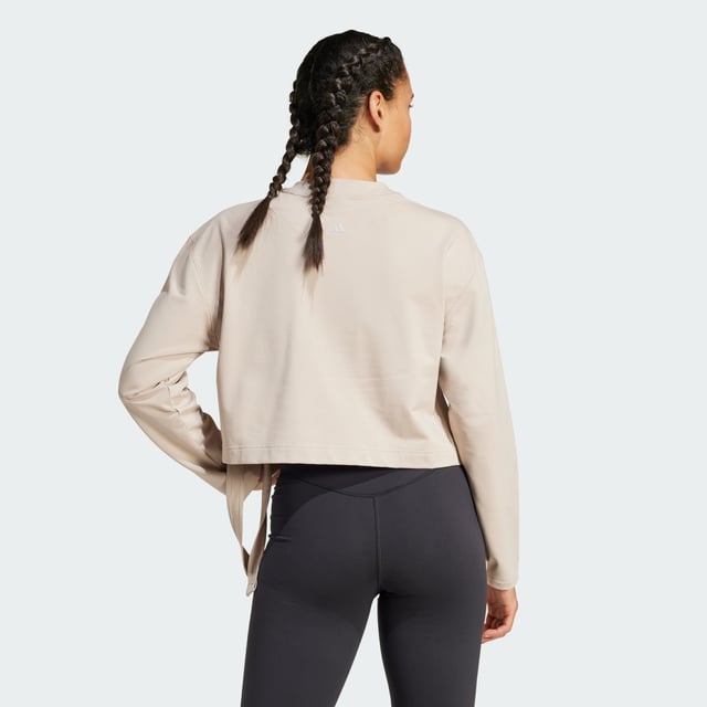 Take your yoga flow from studio to city in this yoga cover-up. Made for comfort inside and out, this soft French terry top keeps you cosy before, during and after your practice. adidas AEROREADY keeps you dry when the heat is on. Slightly cropped and with hem ties, this cover-up layers perfectly over your favourite yoga bra.By choosing recycled, adidas are able to reuse materials that have already been created, which helps to reduce waste. Renewable materials choices will help us to remove our reliance on finite resources. Our products made with a blend of recycled and renewable materials feature at least 70% total of these materials.  -