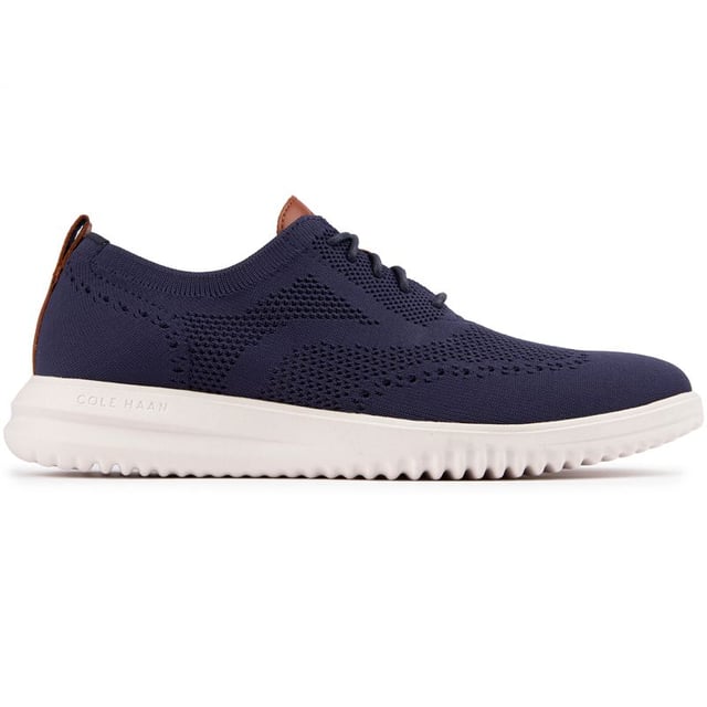 The Cole Haan Grand+ Stitchlite trainers look sharp and will give you a spring in your step thanks to their lightweight Stitchlite uppers and responsive Grand 360 sole technology. These sleek navy shoes showcase classic brogue detailing and hug your feet with their sock-like fit and plush comfort insole. Finished with Cole Haan branding, the contemporary Stitchlite sneaker keeps it simple yet stylish. So lace up, go the distance and feel the freedom of near-weightless comfort in the Cole Haan Stitchlite.