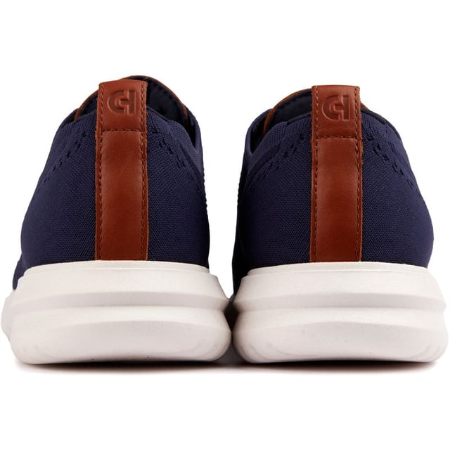 The Cole Haan Grand+ Stitchlite trainers look sharp and will give you a spring in your step thanks to their lightweight Stitchlite uppers and responsive Grand 360 sole technology. These sleek navy shoes showcase classic brogue detailing and hug your feet with their sock-like fit and plush comfort insole. Finished with Cole Haan branding, the contemporary Stitchlite sneaker keeps it simple yet stylish. So lace up, go the distance and feel the freedom of near-weightless comfort in the Cole Haan Stitchlite.