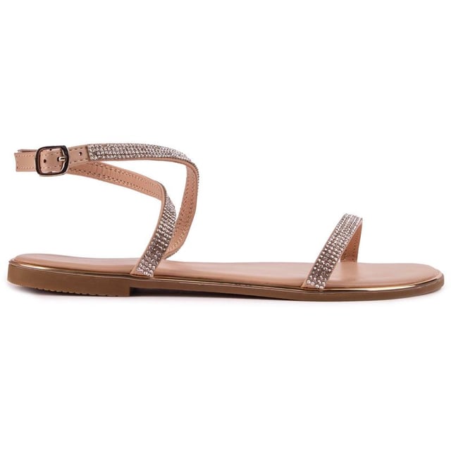 Las sandalias Lane de SOLE son un par de zapatos planos metálicos color nude y bronce con un toque súper chic y ultrafemenino. Con correas delicadamente cubiertas de diamantes y una correa ajustable en el tobillo, este modelo glamuroso es perfecto para un día soleado y una cálida noche de verano.