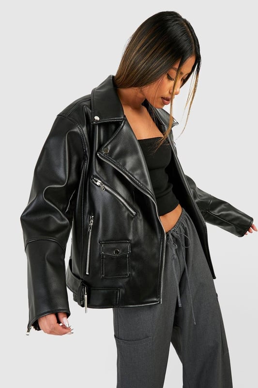 Oversized silhouette for a bold, contemporary look
        Belted design for adjustable fit and added style
        Classic biker jacket details including lapels and asymmetric zip
        Multiple functional pockets for practicality
        Versatile PU fabric suitable for various occasions
    
    Make a statement with this oversized belted biker jacket, a must-have piece for the fashion-forward woman. The relaxed fit offers comfort and style, while the belt allows you to customise the silhouette to your liking. Perfect for casual outings, this jacket pairs effortlessly with wide-leg trousers and a crop top for a trendy ensemble. Layer it over a hoodie and leggings for a laid-back weekend look, or throw it on over a midi dress for an edgy contrast. The multiple pockets add functionality, making it ideal for days out with friends or family gatherings. Whether you're heading to a casual dinner or a night out, this versatile jacket will keep you looking chic and feeling confident in true Boohoo style.