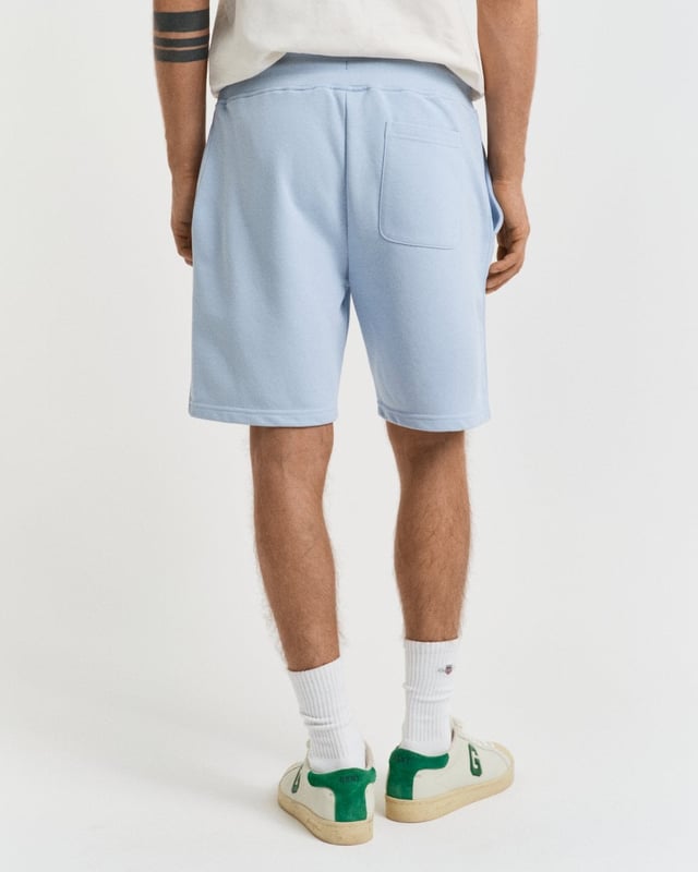  
 These classic sweat shorts are crafted from a soft cotton blend and come in a regular fit. They have a ribbed waistband for added comfort and feature two front pockets, a single back pocket, and a drawstring waist. 


Regular fit
Drawstring waist
Front pockets and back pocket
GANT graphic embroidered at left leg

 87% cotton, 13% polyester 

2009027
 