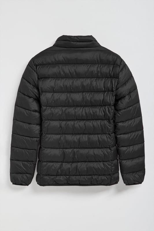 Unsere Ultralight-Herrenjacke Chase zeichnet sich durch ein modernes und funktionelles Design aus. Die leichte Steppung wärmt, ohne den Komfort zu beeinträchtigen. Sie ist ohne Kapuze und mit Reißverschluss ausgestattet und verfügt über zwei Seitentaschen und eine Innentasche mit Reißverschluss für zusätzliche Funktionalität. Das Kleidungsstück ist wasserabweisend, jedoch nicht völlig wasserdicht, was es zu einer perfekten Wahl für eine Vielzahl von Wetterbedingungen macht. Unser neuer gummierter, farblich angepasster Rigby Go Aufnäher auf der Brust, die schrägen Einsätze und das Futter in Kontrastfarbe machen dieses Kleidungsstück zu einem modernen Klassiker.