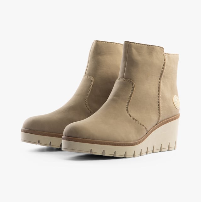 Rieker Rieker Y5065-64 Womens Boots Beige

 Upper Material: Synthetic Leather

Lining Material: Textile

Sole Material: Rubber

Closure/Fastening: Zip

Features: Comfort

Heel Type: Wedge

Toe Shape: Round

Shoe Width: Relaxed

Item Weight: 0.8 KG

Heel Height: Medium (5-7.4cm)

Shoe Shaft Height: Ankle

Boot Style: Ankle Boots

Gift Boxed: No
Product Code: Y5065-64