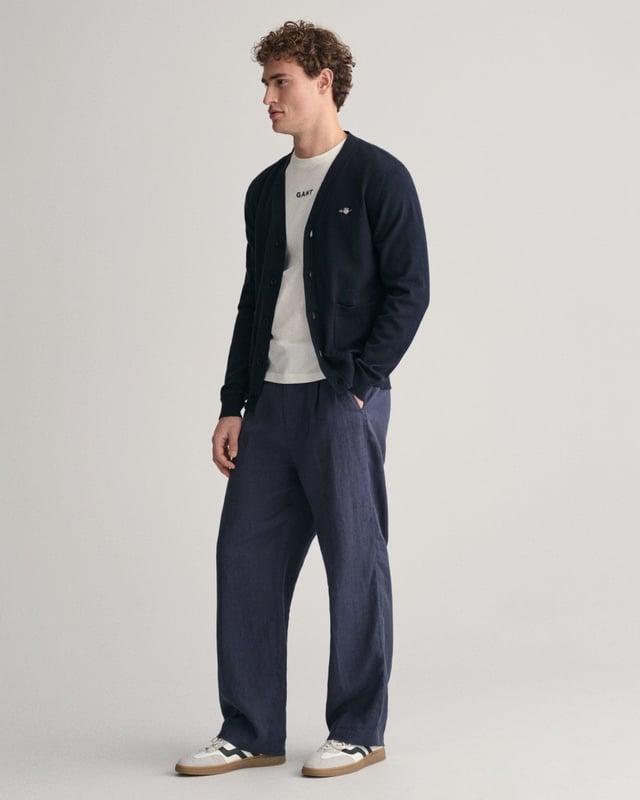 This durable and sophisticated cardigan from GANT is crafted in 100% cotton. Cut for a regular fit, it features a V-neck, knitted pockets, branded corozo buttons and ribbed detailing at the hem and cuffs. This piece is accented with a GANT shield graphic embroidered at the chest. 

Regular fit
V-neck
Knitted pockets
Rib detailing at hem and cuffs
GANT graphic embroidered at chest

100% cotton
8030556
 