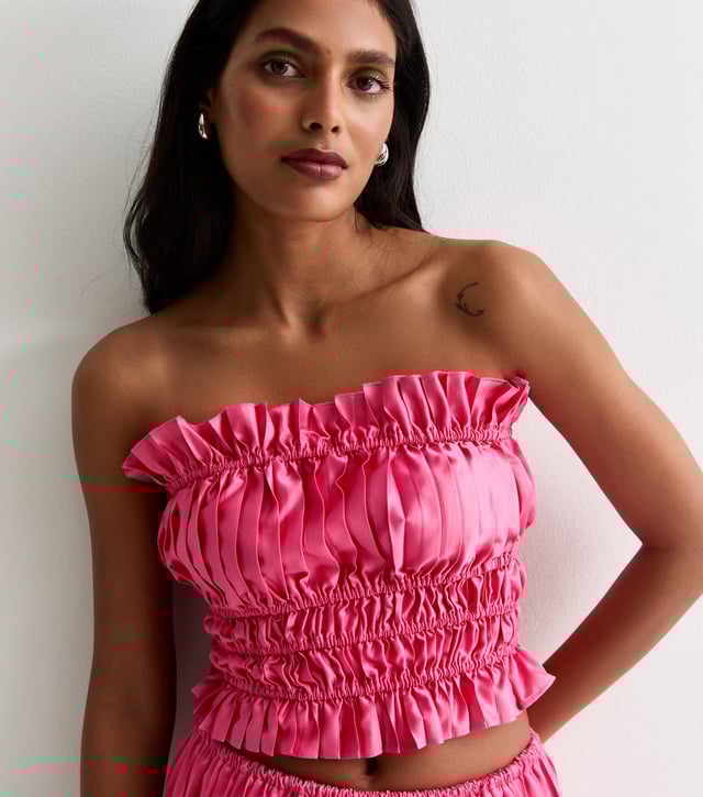 Indulge in luxury and elevate your style with our Hot Pink Ruched Bandeau Top. The stunning hot pink hue and ruched detailing add a touch of sophistication to your outfit, while the bandeau cut ensures a flattering fit. Step out in confidence and make a statement with this premium piece.