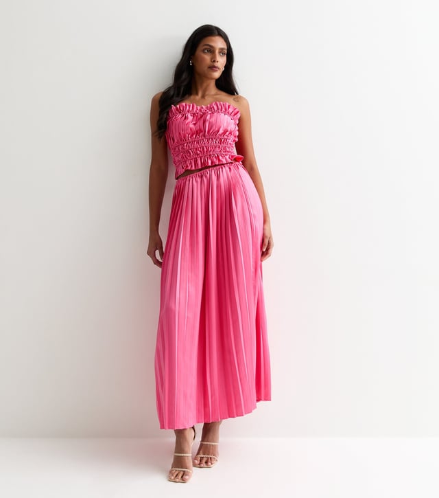 Indulge in luxury and elevate your style with our Hot Pink Ruched Bandeau Top. The stunning hot pink hue and ruched detailing add a touch of sophistication to your outfit, while the bandeau cut ensures a flattering fit. Step out in confidence and make a statement with this premium piece.