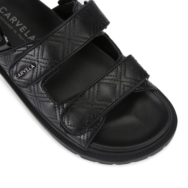 The Carvela Rosa Sandal is crafted in a black leather alternative. There is overstitch quilting in a diamond style across the upper straps. There is a gunmetal branding detail on the top strap.
