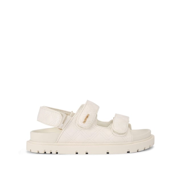 The Carvela Rosa Sandal is crafted in a white leather alternative. There is overstitch quilting in a diamond style across the upper straps. There is a gold branding detail on the top strap.