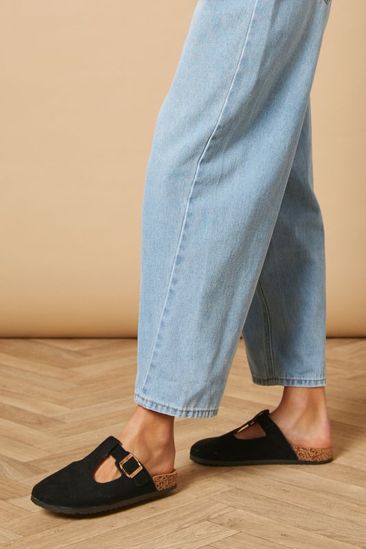 T-bar design for a classic Mary Jane silhouette
        Closed toe for added protection and versatility
        Comfortable footbed for all-day wear
        Faux suede upper for a luxurious look and feel
        Flat heel between 0 and 2cm for easy walking
    
    Step into effortless style with these Emmeline faux suede mules from Oasis. The T-bar Mary Jane design offers a charming nod to vintage aesthetics while maintaining a contemporary edge. Perfect for daywear, these versatile flats can take you from casual brunches to family gatherings with ease. Pair them with cropped jeans and a crisp white tee for a laid-back weekend look, or style them with a flowy midi dress for a more polished ensemble. The closed toe and comfortable footbed ensure all-day comfort, making these mules ideal for city exploring or leisurely strolls in the park. Their flat heel provides stability without sacrificing style, allowing you to navigate your day with confidence and grace.