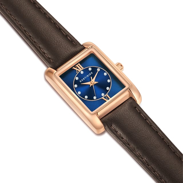 GENERAL INFORMATION:  • Targetgroup: Female  • Wristwatch: No Special Functions  • Display: analogue  • Weight of watch w/o box (gr.) - approx.: 21  MOVEMENT:  • Movement: Quartz  • Term of Movement: 2035  • Origin of movement: Japan  BRACELET:  • Material of bracelet/strap: Genuine leather  • Plating of bracelet/strap: None  • Finishing of bracelet/strap: Smooth  • Finishing/Decoration of bracelet/strap: Seam  • Clasp/Closure/Buckle: Buckle  • Color of bracelet/strap: Brown  • Length of bracelet/strap (mm) approx.: 190,0  • Width of bracelet/strap (mm) approx.: 14,0  • Style/Design of bracelet/strap: No imprint  • Bracelet/strap adjustable?: No  CASE:  • Shape of case: Rectangular  • Size/Diameter of case in mm . approx.: 20,5 x 30,8  • Height of case in mm: 8,4  • Case material: Metal (Alloy)  • Surface of case: Polished  • Bezel/Topring: Fixed  • Finishing/Decoration of case: None  • Material of case back: Stainless steel  • Lock of case back: No screwed-in crown  • Color of case: Rosegold  • Coating/Plating (Case): Ion-Plating (IP)  • Type/Form of crystal: Flat  • Material of crystal: Mineral crystal  DIAL:  • Size jewelry care cloth: Hour, Minute, Second  • Indices: Roman numerals/points  • Material of dial: Brass  • Structure/pattern of dial: Flat/sunray  • Color of dial: Blue  PUSHER, CROWN, HAND:  • Pusher: None  • Corrector: No  • Crown: No screwed-in crown  • Type of hands: Dauphine hands  • Luminescent (hands): No  PACKAGING & SCOPE OF DELIVERY:  • Box: Yes  • Service booklet: Yes  • Manual: Yes