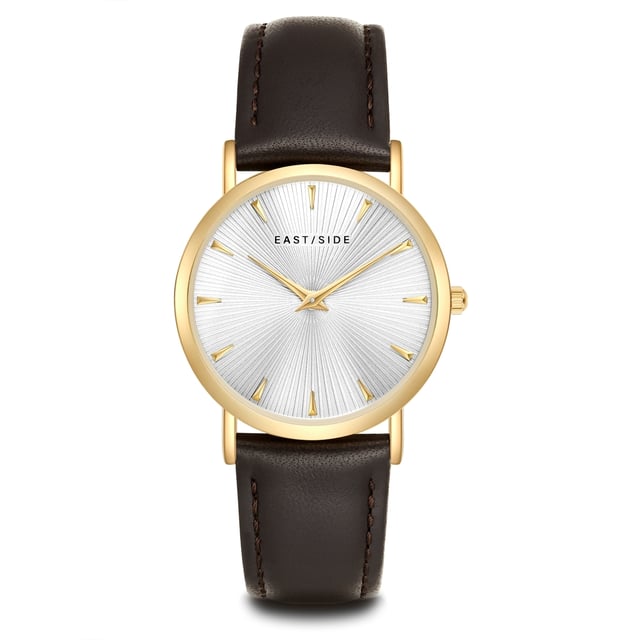 GENERAL INFORMATION:  • Targetgroup: Female  • Wristwatch: No Special Functions  • Display: analogue  • Weight of watch w/o box (gr.) - approx.: 26,0  MOVEMENT:  • Movement: Quartz  • Term of Movement: 2025  • Origin of movement: Japan  BRACELET:  • Material of bracelet/strap: Genuine leather  • Plating of bracelet/strap: None  • Finishing of bracelet/strap: Smooth  • Finishing/Decoration of bracelet/strap: Seam  • Clasp/Closure/Buckle: Buckle  • Color of bracelet/strap: Dark brown  • Length of bracelet/strap (mm) approx.: 190,0  • Width of bracelet/strap (mm) approx.: 18,0  • Style/Design of bracelet/strap: No imprint  • Bracelet/strap adjustable?: No  CASE:  • Shape of case: Round  • Size/Diameter of case in mm . approx.: 33,0  • Height of case in mm: 6,7  • Case material: Metal (Alloy)  • Surface of case: Polished  • Bezel/Topring: Fixed  • Finishing/Decoration of case: None  • Material of case back: Stainless steel  • Lock of case back: No screwed-in crown  • Color of case: Yellowgold  • Coating/Plating (Case): Ion-Plating (IP)  • Type/Form of crystal: Flat  • Material of crystal: Mineral crystal  • Water resistant (ATM): 3  DIAL:  • Size jewelry care cloth: Hour, Minute  • Indices: Line indices  • Material of dial: Brass  • Structure/pattern of dial: sunray  • Color of dial: White  PUSHER, CROWN, HAND:  • Pusher: None  • Corrector: No  • Crown: No screwed-in crown  • Type of hands: Dauphine hands  • Luminescent (hands): No  PACKAGING & SCOPE OF DELIVERY:  • Box: Yes  • Service booklet: Yes  • Manual: Yes