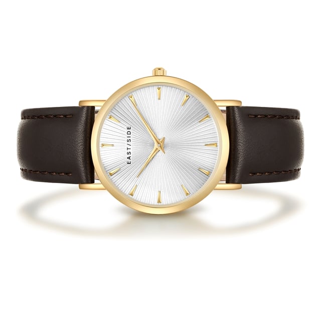 GENERAL INFORMATION:  • Targetgroup: Female  • Wristwatch: No Special Functions  • Display: analogue  • Weight of watch w/o box (gr.) - approx.: 26,0  MOVEMENT:  • Movement: Quartz  • Term of Movement: 2025  • Origin of movement: Japan  BRACELET:  • Material of bracelet/strap: Genuine leather  • Plating of bracelet/strap: None  • Finishing of bracelet/strap: Smooth  • Finishing/Decoration of bracelet/strap: Seam  • Clasp/Closure/Buckle: Buckle  • Color of bracelet/strap: Dark brown  • Length of bracelet/strap (mm) approx.: 190,0  • Width of bracelet/strap (mm) approx.: 18,0  • Style/Design of bracelet/strap: No imprint  • Bracelet/strap adjustable?: No  CASE:  • Shape of case: Round  • Size/Diameter of case in mm . approx.: 33,0  • Height of case in mm: 6,7  • Case material: Metal (Alloy)  • Surface of case: Polished  • Bezel/Topring: Fixed  • Finishing/Decoration of case: None  • Material of case back: Stainless steel  • Lock of case back: No screwed-in crown  • Color of case: Yellowgold  • Coating/Plating (Case): Ion-Plating (IP)  • Type/Form of crystal: Flat  • Material of crystal: Mineral crystal  • Water resistant (ATM): 3  DIAL:  • Size jewelry care cloth: Hour, Minute  • Indices: Line indices  • Material of dial: Brass  • Structure/pattern of dial: sunray  • Color of dial: White  PUSHER, CROWN, HAND:  • Pusher: None  • Corrector: No  • Crown: No screwed-in crown  • Type of hands: Dauphine hands  • Luminescent (hands): No  PACKAGING & SCOPE OF DELIVERY:  • Box: Yes  • Service booklet: Yes  • Manual: Yes