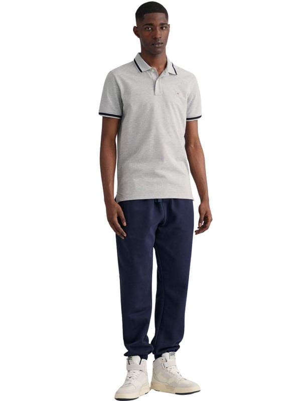 Elevate your wardrobe with our timeless Regular fit Short sleeves cotton piqué shirt. Featuring herringbone detailing on the collar and cuffs and an embroidered GANT shield on the chest, this sporty classic is made of lightweight, breathable fabric (2063005)