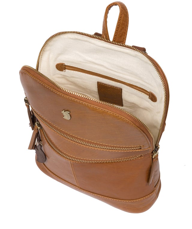 Handcrafted from natural leather for a beautifully textured finish the 'Francisca' backpack from Conkca London features plentiful on-the-go storage. The main zipped compartment comes lined with natural and untreated 100% cotton with two interior pockets, ideal for a smartphone and keys. Dual zips on the front of the backpack provide extra storage solutions. Comes with adjustable and durable fabric shoulder straps finished with the inimitable Conkca squirrel logo and charm.
