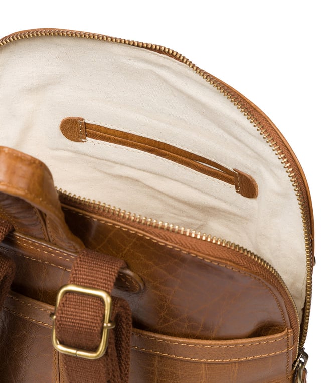 Handcrafted from natural leather for a beautifully textured finish the 'Francisca' backpack from Conkca London features plentiful on-the-go storage. The main zipped compartment comes lined with natural and untreated 100% cotton with two interior pockets, ideal for a smartphone and keys. Dual zips on the front of the backpack provide extra storage solutions. Comes with adjustable and durable fabric shoulder straps finished with the inimitable Conkca squirrel logo and charm.