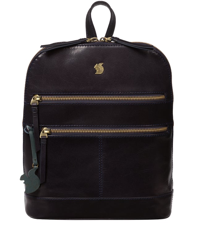 Handcrafted from natural leather for a beautifully textured finish the 'Francisca' backpack from Conkca London features plentiful on-the-go storage. The main zipped compartment comes lined with natural and untreated 100% cotton with two interior pockets, ideal for a smartphone and keys. Dual zips on the front of the backpack provide extra storage solutions. Comes with adjustable and durable fabric shoulder straps finished with the inimitable Conkca squirrel logo and charm.