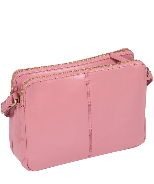 The 'Drew' cross-body bag from Concka London is crafted from full grain genuine leather that has a beautiful finish. The dual zip pockets featured on this accessory make organisation that a little bit easier. Lined with 100% untreated cotton and comes with an adjustable matching leather strap, which has a maximum drop length of 70cm. Finished with a zipped pocket to the front adorned with the cute Conkca London squirrel zip pull and an embossed Conkca London logo.
