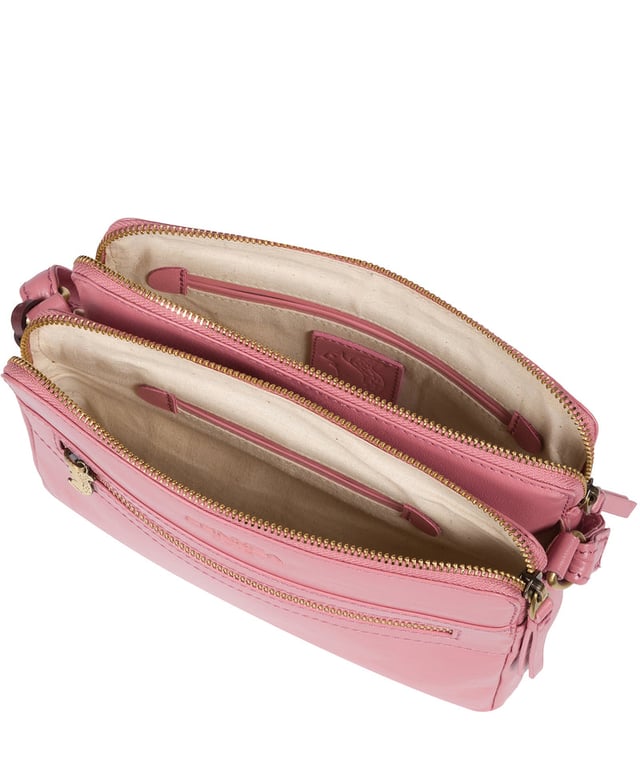 The 'Drew' cross-body bag from Concka London is crafted from full grain genuine leather that has a beautiful finish. The dual zip pockets featured on this accessory make organisation that a little bit easier. Lined with 100% untreated cotton and comes with an adjustable matching leather strap, which has a maximum drop length of 70cm. Finished with a zipped pocket to the front adorned with the cute Conkca London squirrel zip pull and an embossed Conkca London logo.