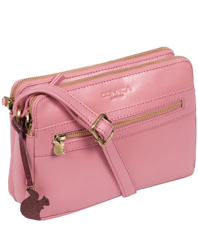 The 'Drew' cross-body bag from Concka London is crafted from full grain genuine leather that has a beautiful finish. The dual zip pockets featured on this accessory make organisation that a little bit easier. Lined with 100% untreated cotton and comes with an adjustable matching leather strap, which has a maximum drop length of 70cm. Finished with a zipped pocket to the front adorned with the cute Conkca London squirrel zip pull and an embossed Conkca London logo.