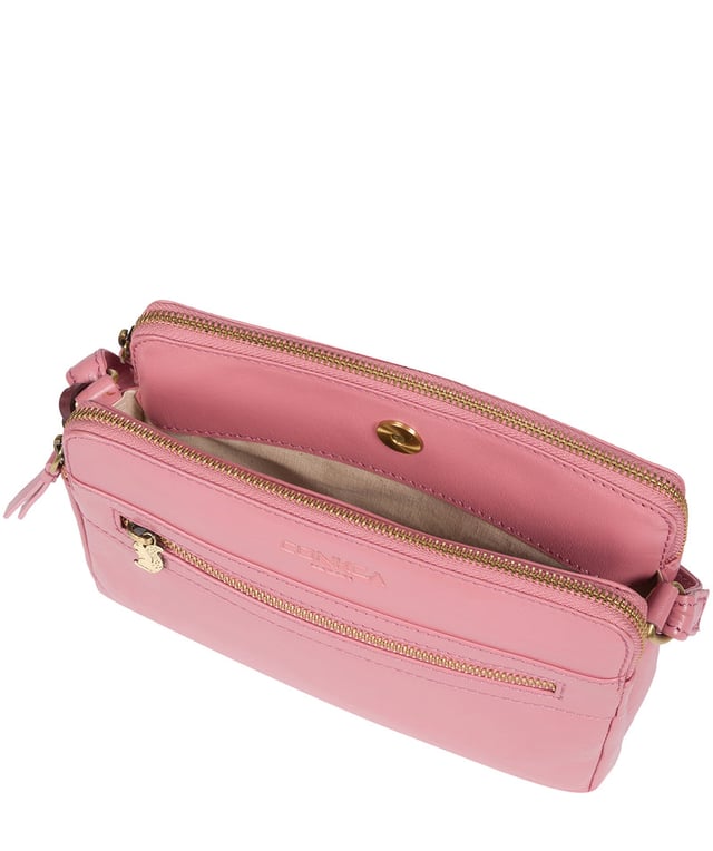 The 'Drew' cross-body bag from Concka London is crafted from full grain genuine leather that has a beautiful finish. The dual zip pockets featured on this accessory make organisation that a little bit easier. Lined with 100% untreated cotton and comes with an adjustable matching leather strap, which has a maximum drop length of 70cm. Finished with a zipped pocket to the front adorned with the cute Conkca London squirrel zip pull and an embossed Conkca London logo.