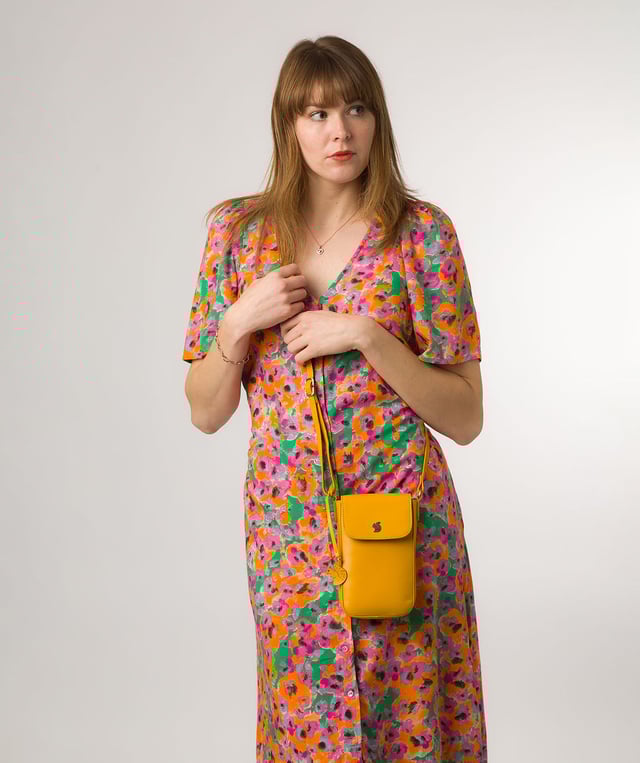The 'Buzz' small cross body bag from Conkca London is handcrafted from genuine leather for a beautiful finish. A magnetic press-stud secures the fold-over top and conceals the natural and untreated 100% cotton lined central compartment. Ample storage space is provided by two slip pockets that are ideal for maintaining an organised bag. Comes with an adjustable leather strap alongside gold metal fittings. Adorned with the iconic Conkca logo and charm.