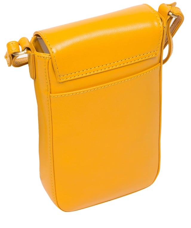 The 'Buzz' small cross body bag from Conkca London is handcrafted from genuine leather for a beautiful finish. A magnetic press-stud secures the fold-over top and conceals the natural and untreated 100% cotton lined central compartment. Ample storage space is provided by two slip pockets that are ideal for maintaining an organised bag. Comes with an adjustable leather strap alongside gold metal fittings. Adorned with the iconic Conkca logo and charm.
