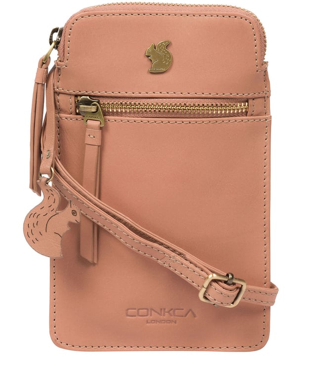The 'Bambino' cross body phone bag from Conkca London is handcrafted from multi-toned leather for a beautiful finish. A zip-over top opens to reveal the main compartment that is the perfect size for a smartphone, lined with natural and untreated 100% cotton. Features a zipped pocket on the front and a slip pocket on the rear, ideal for small essentials. Comes with an adjustable leather strap with a maximum drop length of 70cm. Adorned with the inimitable Conkca squirrel charm and Conkca logos.