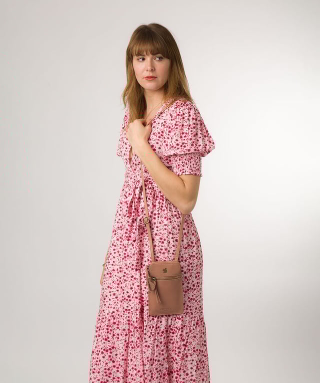 The 'Bambino' cross body phone bag from Conkca London is handcrafted from multi-toned leather for a beautiful finish. A zip-over top opens to reveal the main compartment that is the perfect size for a smartphone, lined with natural and untreated 100% cotton. Features a zipped pocket on the front and a slip pocket on the rear, ideal for small essentials. Comes with an adjustable leather strap with a maximum drop length of 70cm. Adorned with the inimitable Conkca squirrel charm and Conkca logos.
