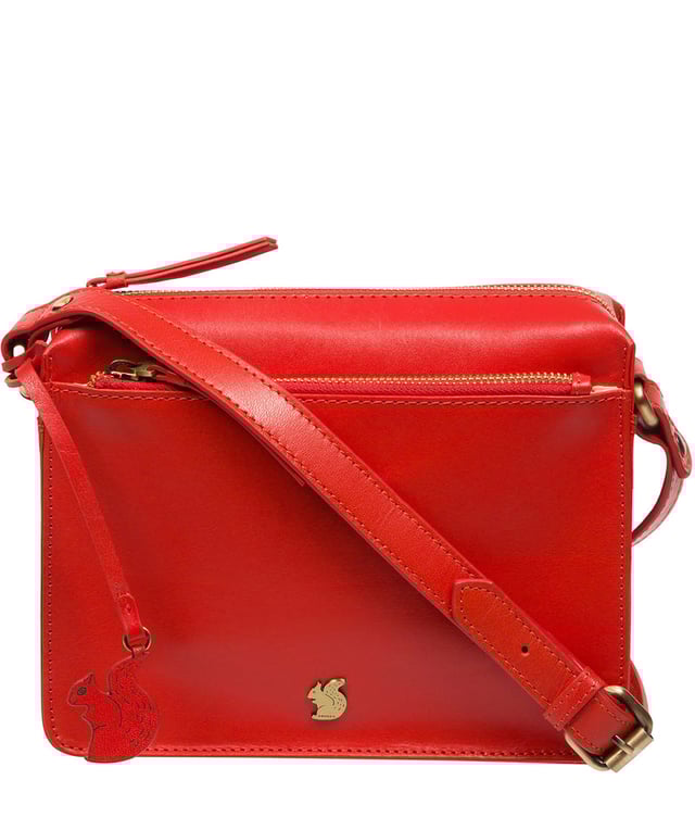 The 'Aurora' cross body bag from Conkca London elevates this classic design with a natural leather exterior for a beautifully smooth finish. A zip-over top conceals the central 100% cotton lined compartment alongside a handy slip pocket. Additional storage space is provided by a zipped pocket and slip pocket, ideal for on-the-go storage. The accessory comes with an adjutable leather strap secured with rustic gold metal fittings; this is all finished with the iconic Conkca London logo and charm.