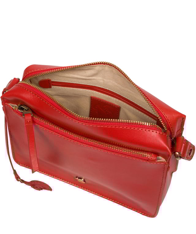 The 'Aurora' cross body bag from Conkca London elevates this classic design with a natural leather exterior for a beautifully smooth finish. A zip-over top conceals the central 100% cotton lined compartment alongside a handy slip pocket. Additional storage space is provided by a zipped pocket and slip pocket, ideal for on-the-go storage. The accessory comes with an adjutable leather strap secured with rustic gold metal fittings; this is all finished with the iconic Conkca London logo and charm.