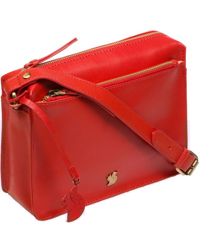 The 'Aurora' cross body bag from Conkca London elevates this classic design with a natural leather exterior for a beautifully smooth finish. A zip-over top conceals the central 100% cotton lined compartment alongside a handy slip pocket. Additional storage space is provided by a zipped pocket and slip pocket, ideal for on-the-go storage. The accessory comes with an adjutable leather strap secured with rustic gold metal fittings; this is all finished with the iconic Conkca London logo and charm.