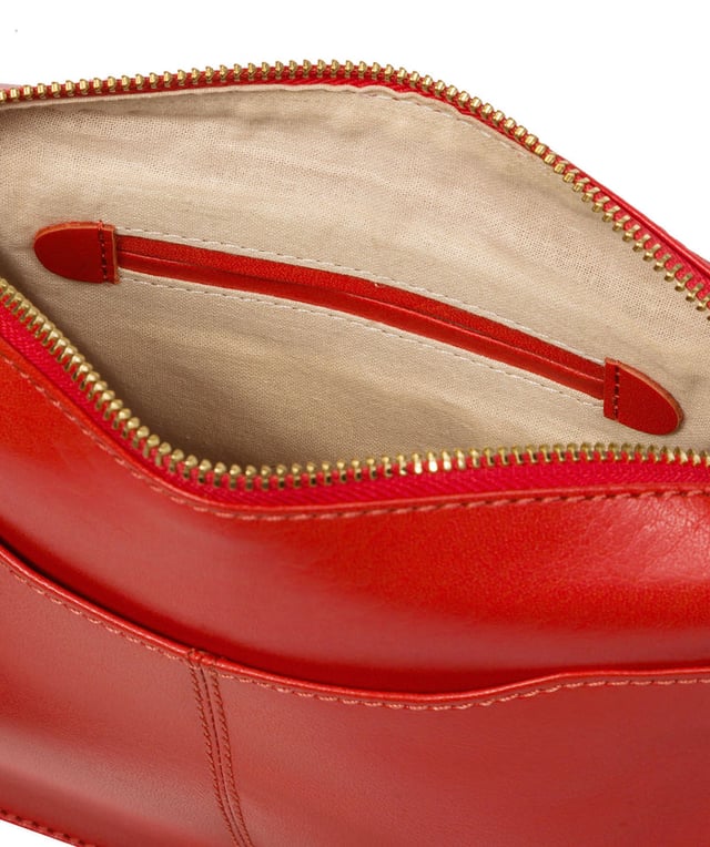 The 'Aurora' cross body bag from Conkca London elevates this classic design with a natural leather exterior for a beautifully smooth finish. A zip-over top conceals the central 100% cotton lined compartment alongside a handy slip pocket. Additional storage space is provided by a zipped pocket and slip pocket, ideal for on-the-go storage. The accessory comes with an adjutable leather strap secured with rustic gold metal fittings; this is all finished with the iconic Conkca London logo and charm.