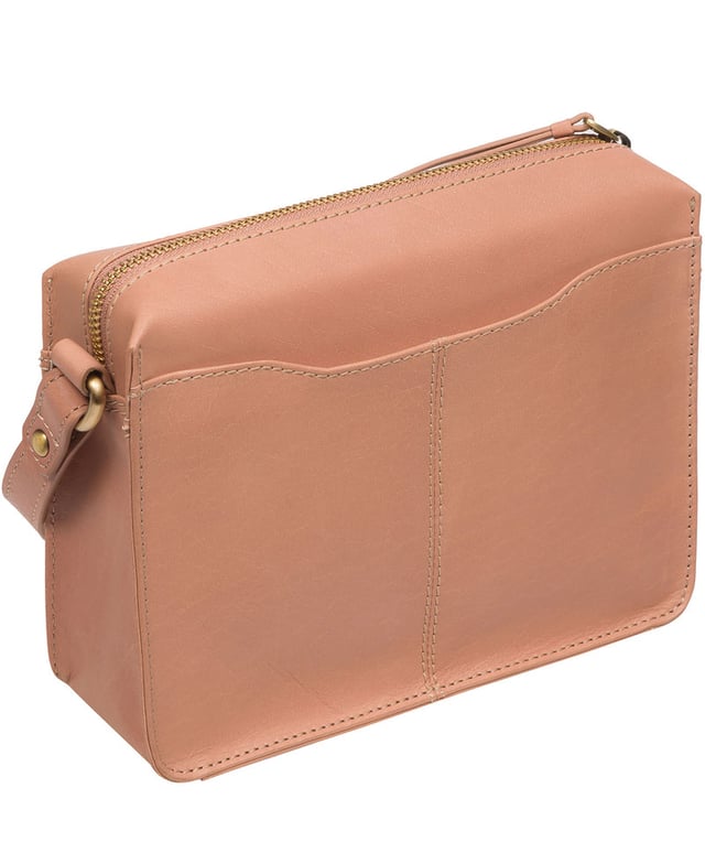 The 'Aurora' cross body bag from Conkca London elevates this classic design with a natural leather exterior for a beautifully smooth finish. A zip-over top conceals the central 100% cotton lined compartment alongside a handy slip pocket. Additional storage space is provided by a zipped pocket and slip pocket, ideal for on-the-go storage. The accessory comes with an adjutable leather strap secured with rustic gold metal fittings; this is all finished with the iconic Conkca London logo and charm.